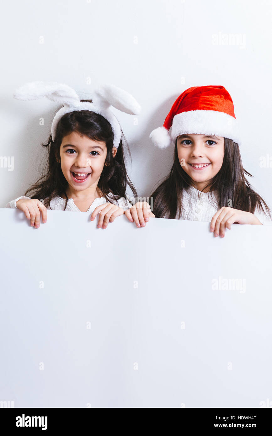 Two girls posing for Christmas and New Year holidays Stock Photo - Alamy
