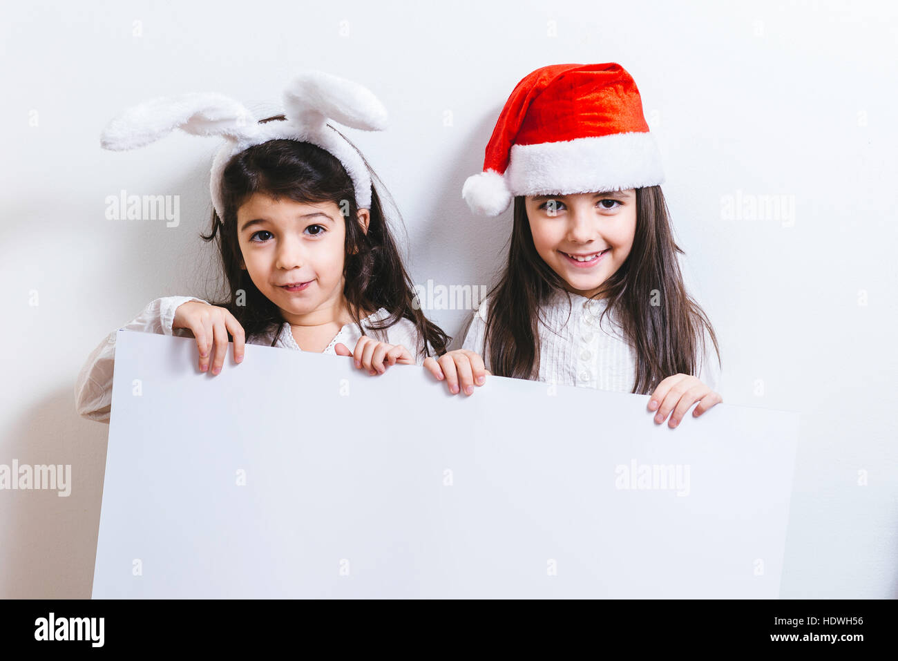 Two girls posing for Christmas and New Year holidays Stock Photo - Alamy