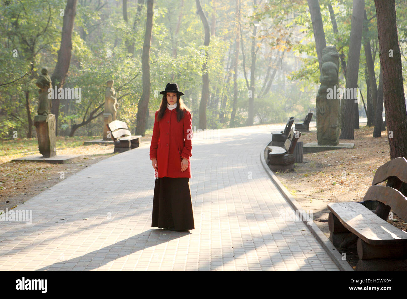 Girl in a black hat for a walk in the autumn park Stock Photo - Alamy