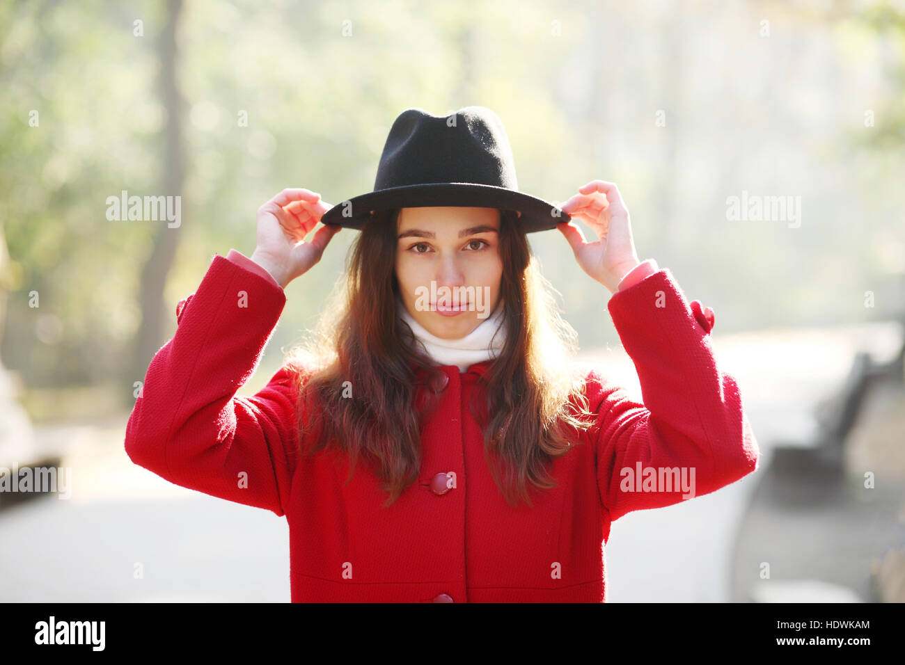 Girl in a black hat for a walk in the autumn park Stock Photo - Alamy