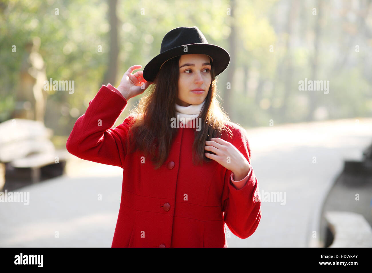 Girl in a black hat for a walk in the autumn park Stock Photo - Alamy