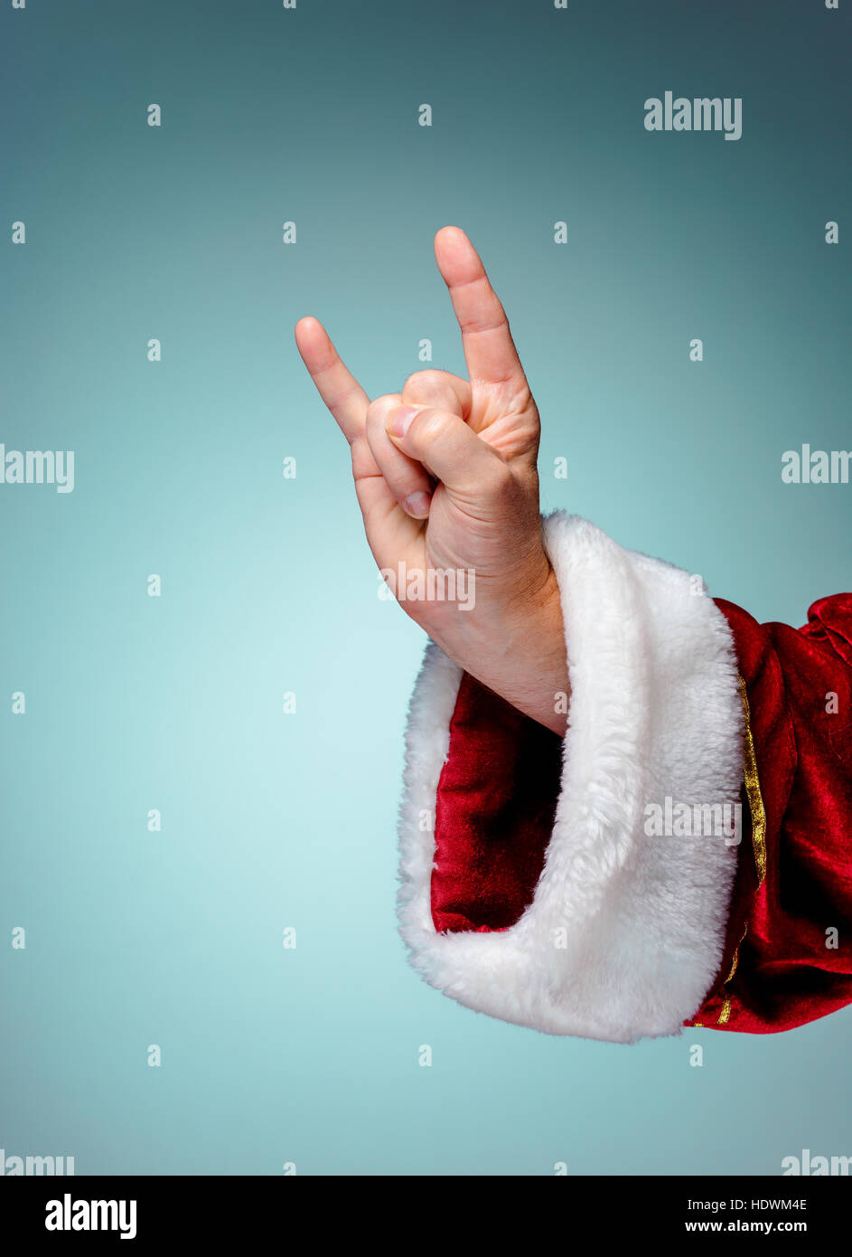 Photo of Santa Claus hand in rocker gesture on blue Stock Photo - Alamy