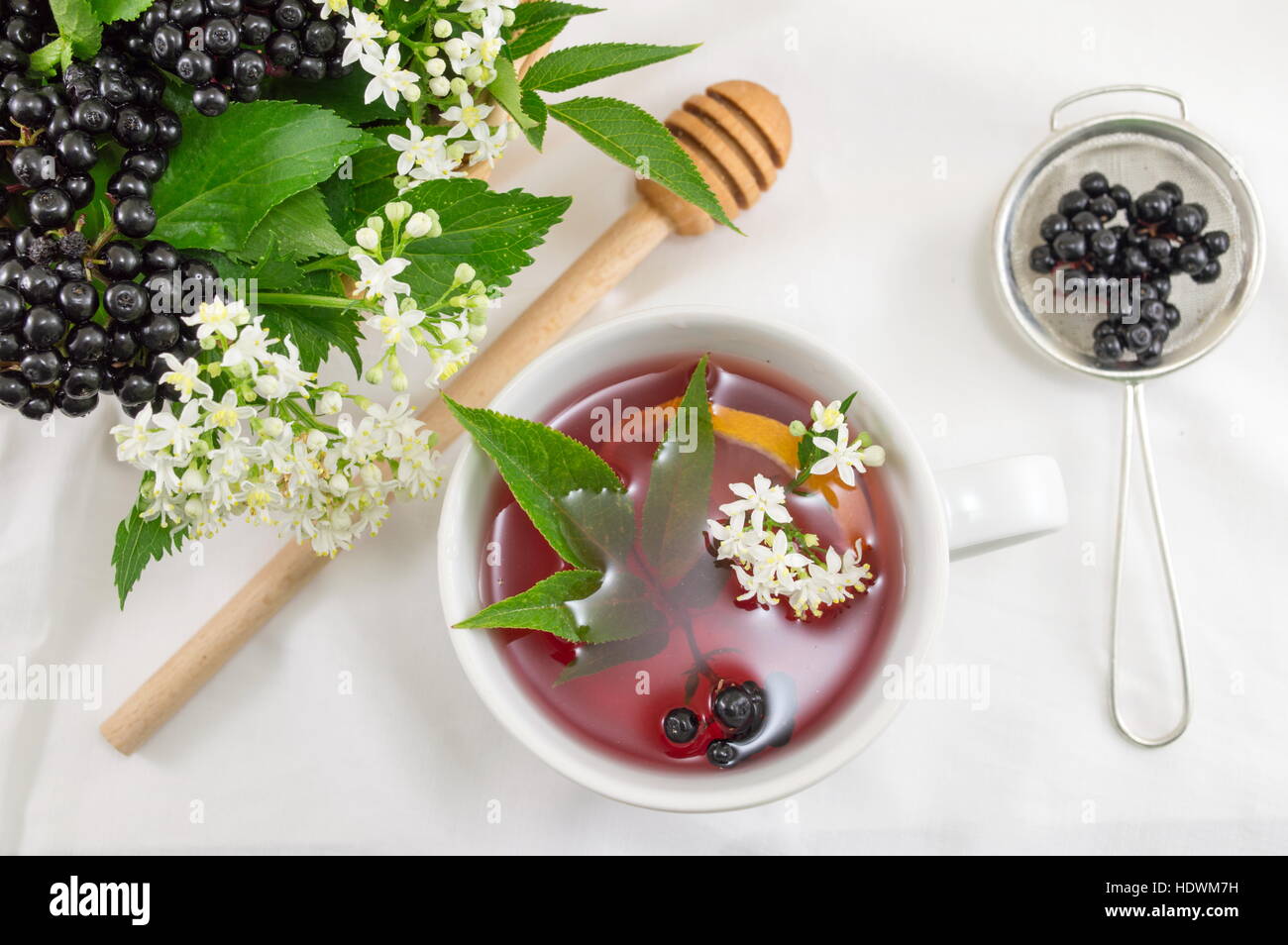 Cup of fresh elderberry tea with berries and honey Stock Photo