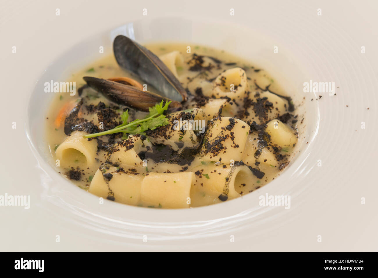 Fish dish with mussels and black of cuttlefish, typical italian food of Mediterranean diet, Cilento dishes. Stock Photo