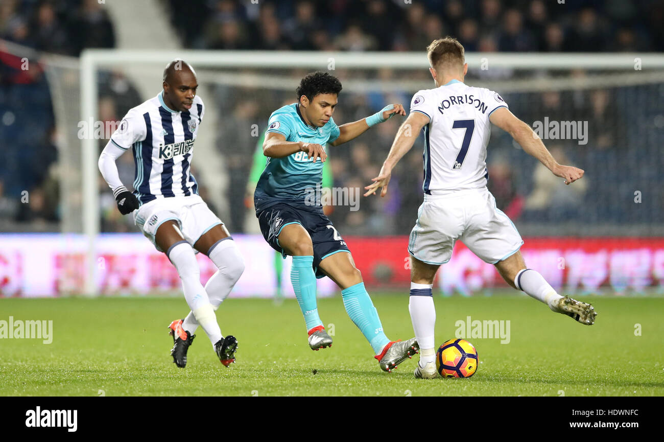 West Bromwich Albion's Allan Nyom (left) and James Morrison (right) battle for the ball with Swansea City's Jefferson Montero during the Premier League match at The Hawthorns, West Bromwich. Stock Photo