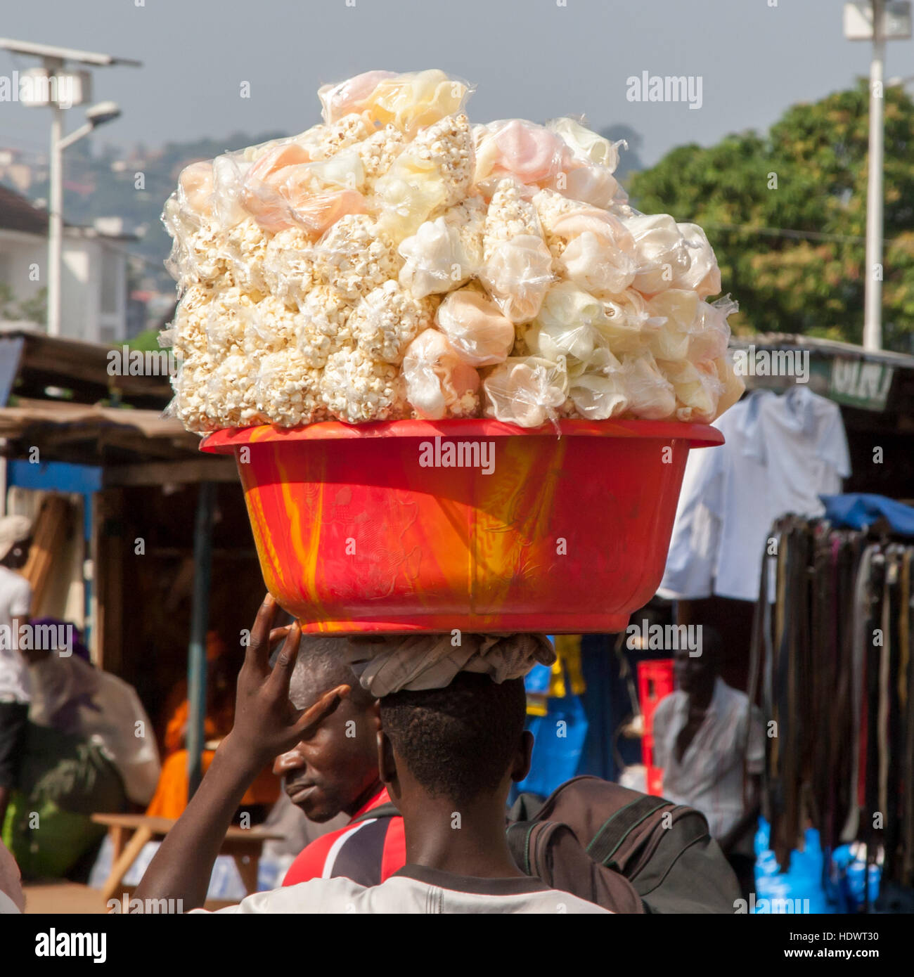 Seller carries a big basket of popcorn on his head Stock Photo