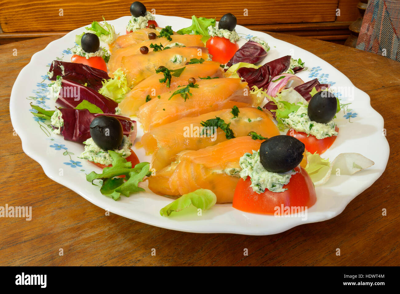 Wonderful and tasty smoked salmon rolls with salad tomatoes olive and cheese Stock Photo