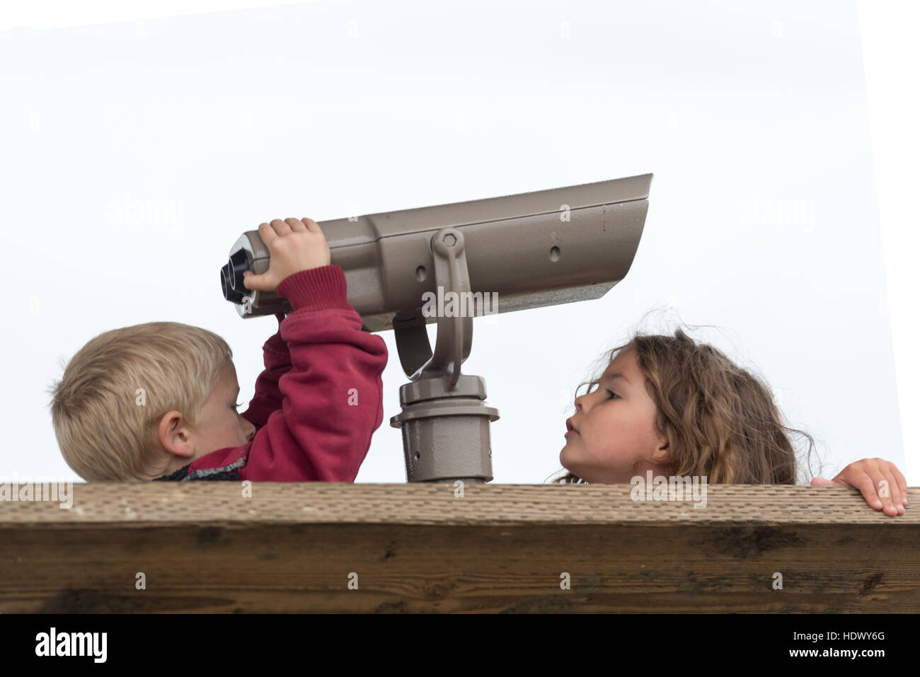 Children with a spotting scope at an observation platform in the Billy Frank Jr. Nisqually National Wildlife Refuge in Western Washington. Stock Photo