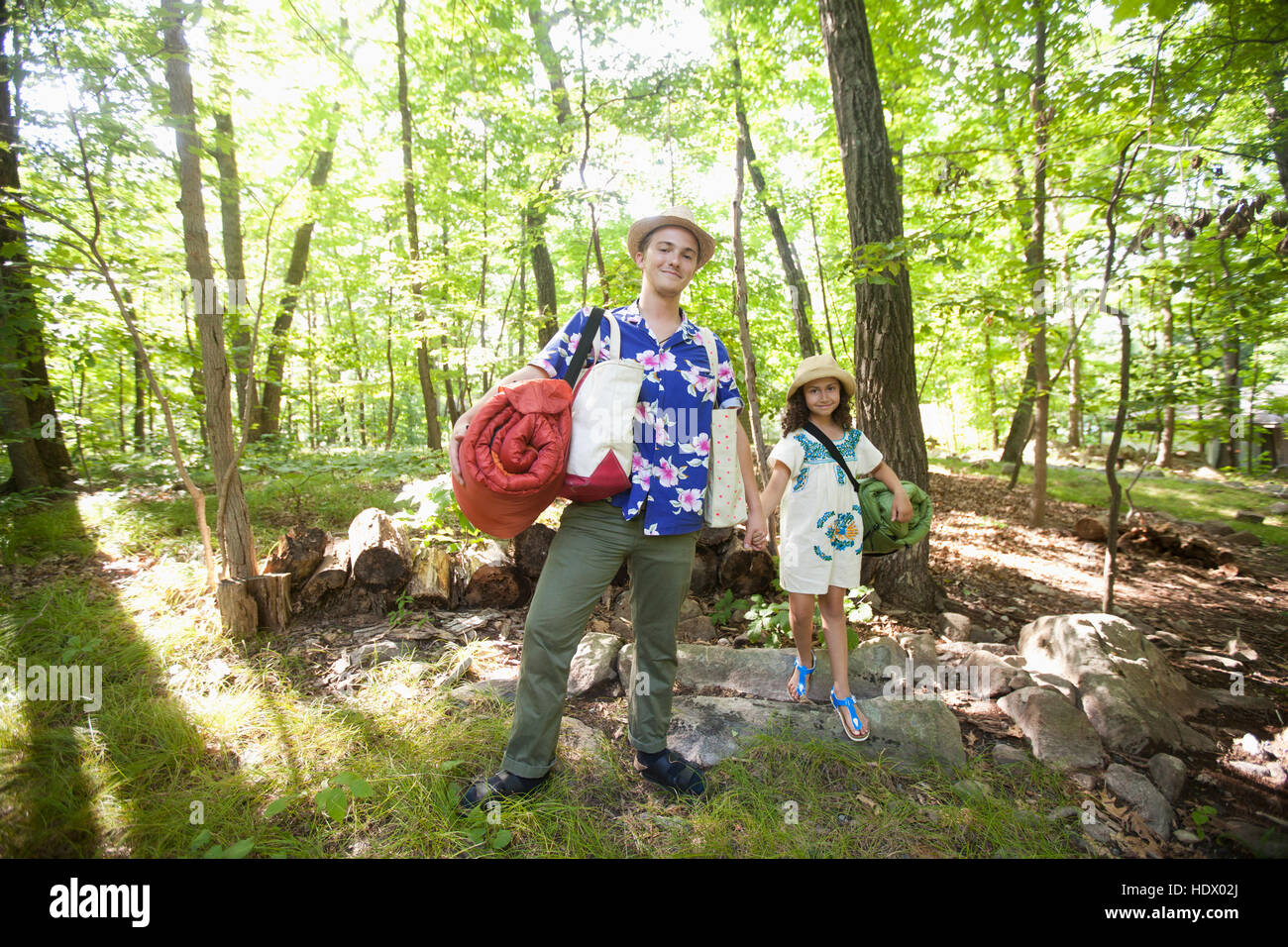 Caucasian father and daughter carrying bags at cabin Stock Photo
