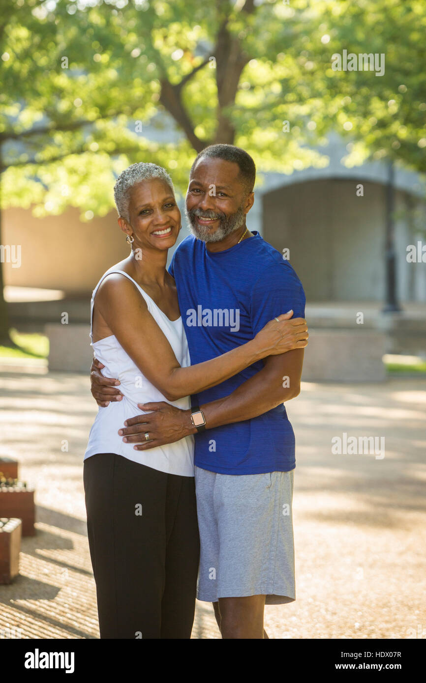Black couple hugging in park Stock Photo - Alamy