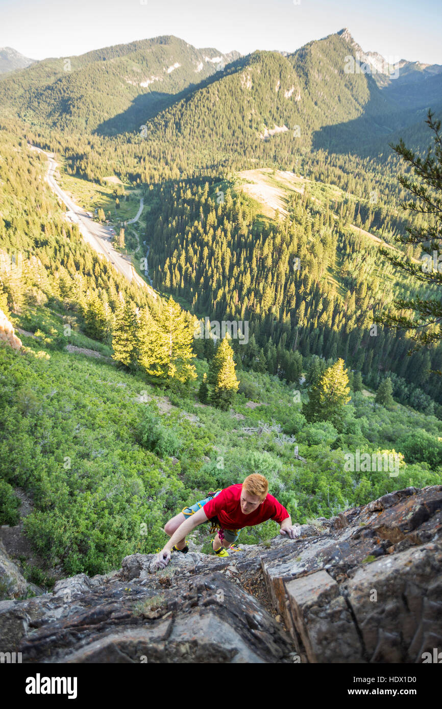 Caucasian man rock climbing Stock Photo - Alamy