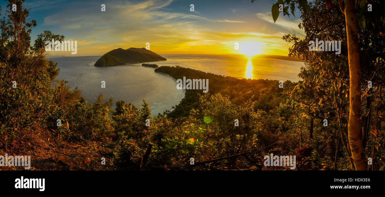 Sunset on horizon with view of wilderness of Kri island in Raja Ampat, West Papua, Indonesia. In this region, one can only meet people from isolated l Stock Photo