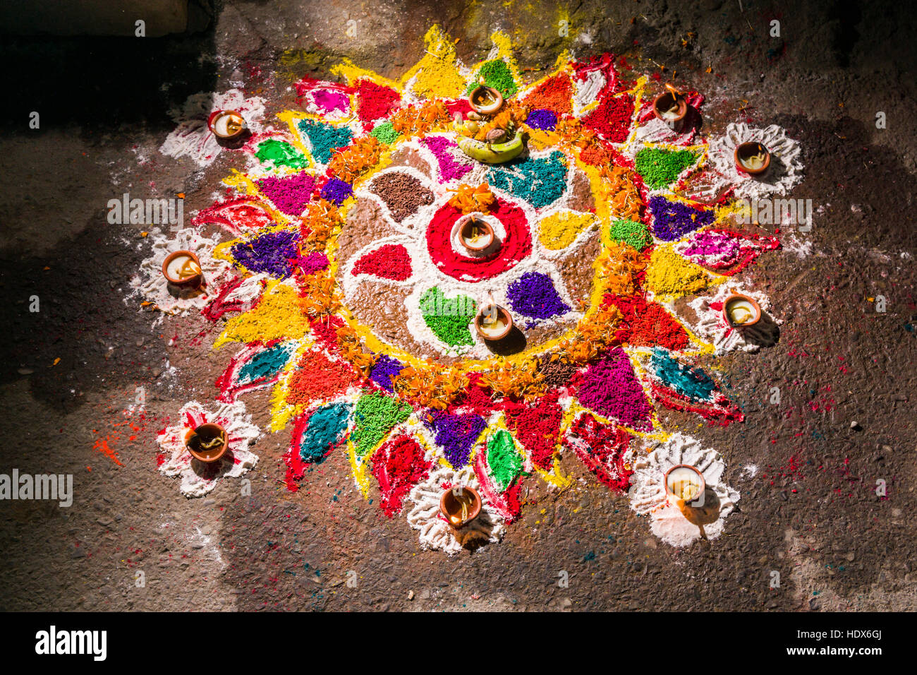 A colorful mandala is made from colorpowder and candles for the Tihar festival Stock Photo
