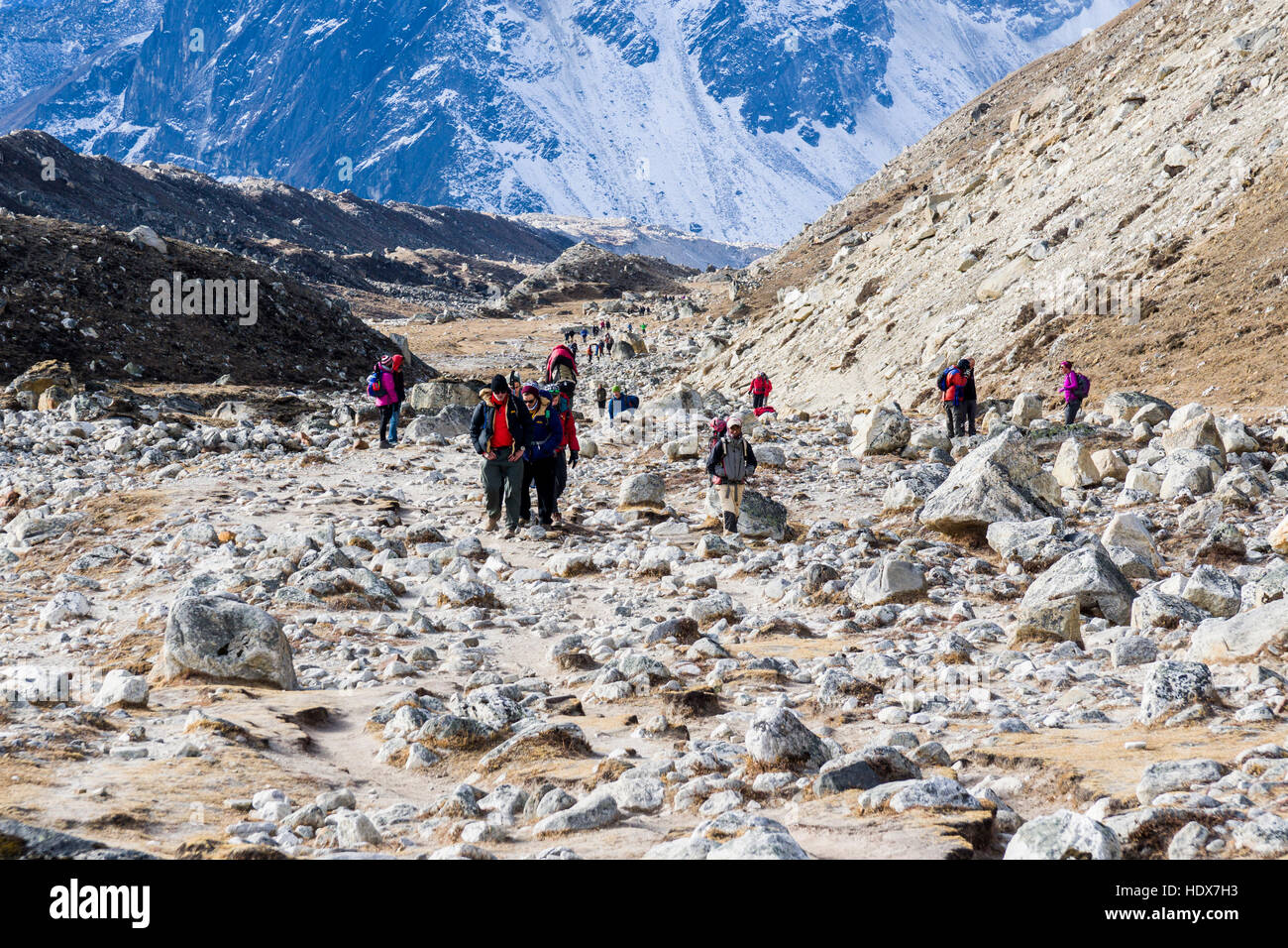 A group of trekkers are walking up the valley Stock Photo