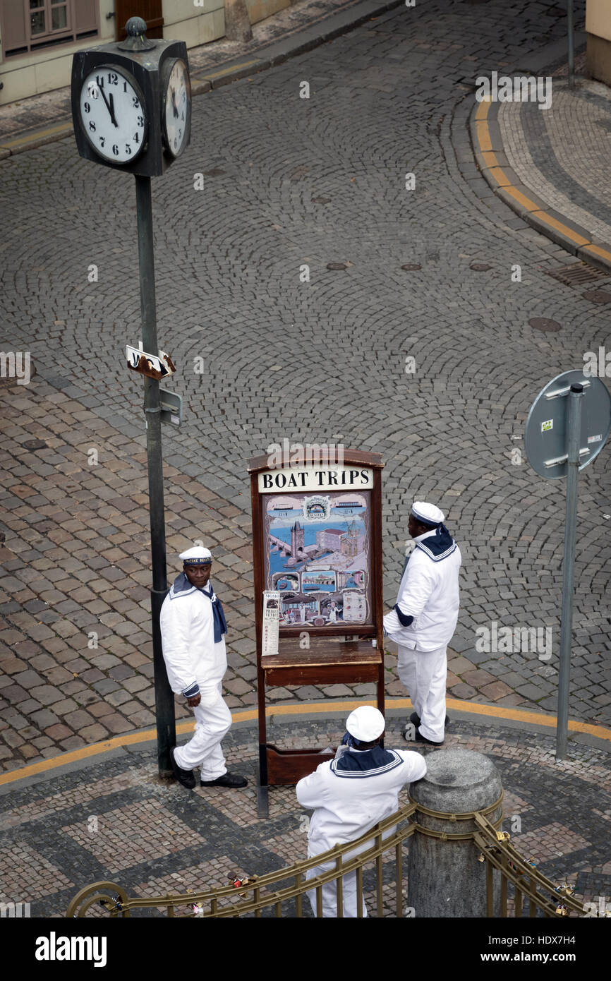 Three men dressed in sailors’ outfits advertise boat trips in Malá Strana, Prague Stock Photo