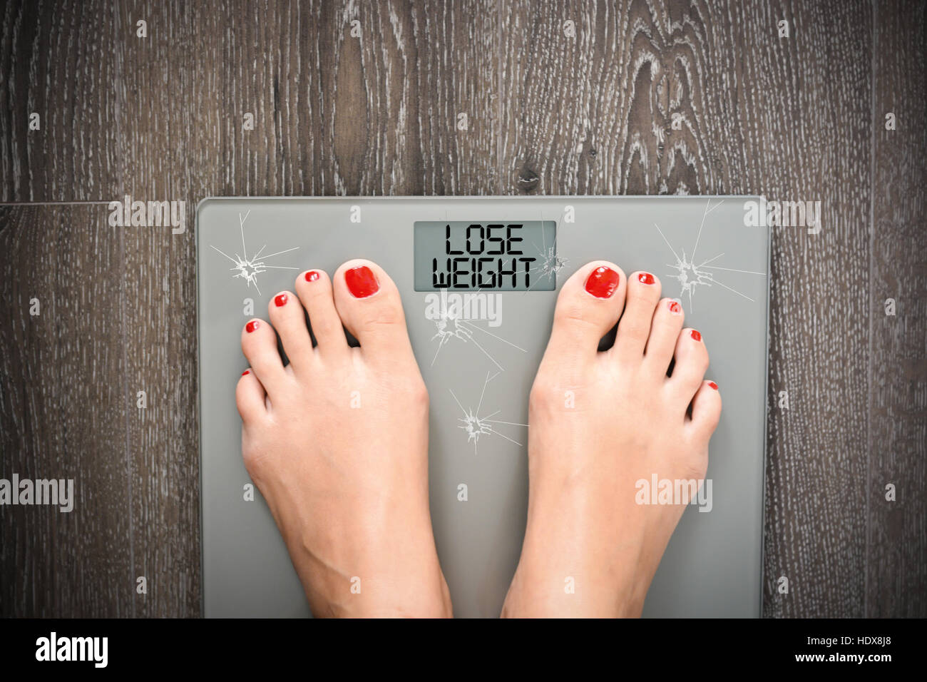 Diet problems concept with weight scale broken glass Stock Photo