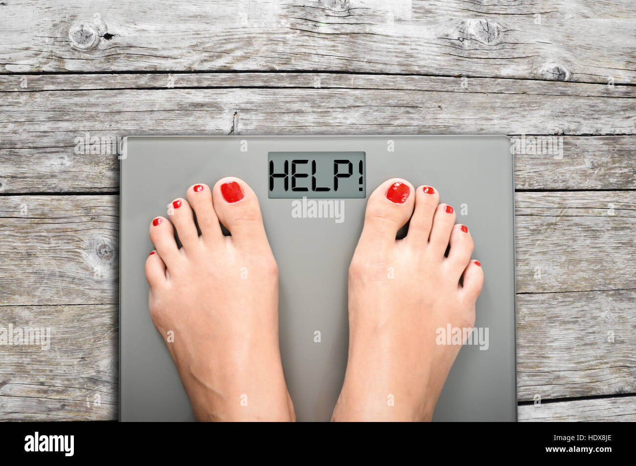 https://c8.alamy.com/comp/HDX8JE/help-to-lose-kilograms-with-woman-feet-stepping-on-a-weight-scale-HDX8JE.jpg