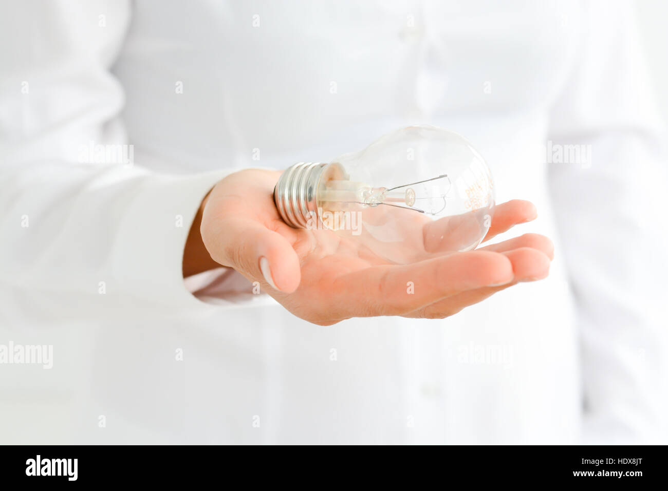Businesswoman holding in hand a light bulb Stock Photo