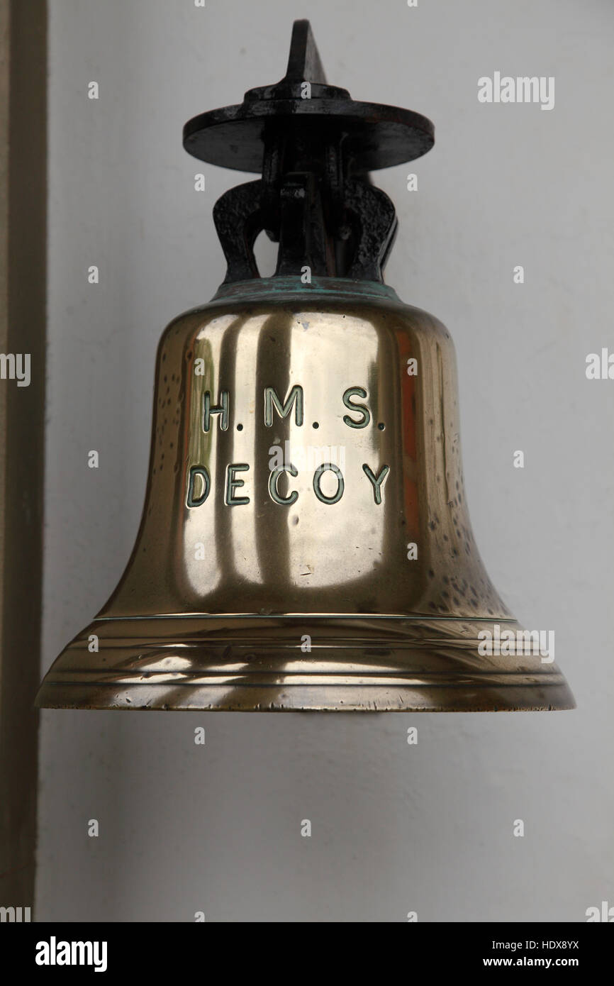 Large brass bell labeled HMS Decoy Stock Photo