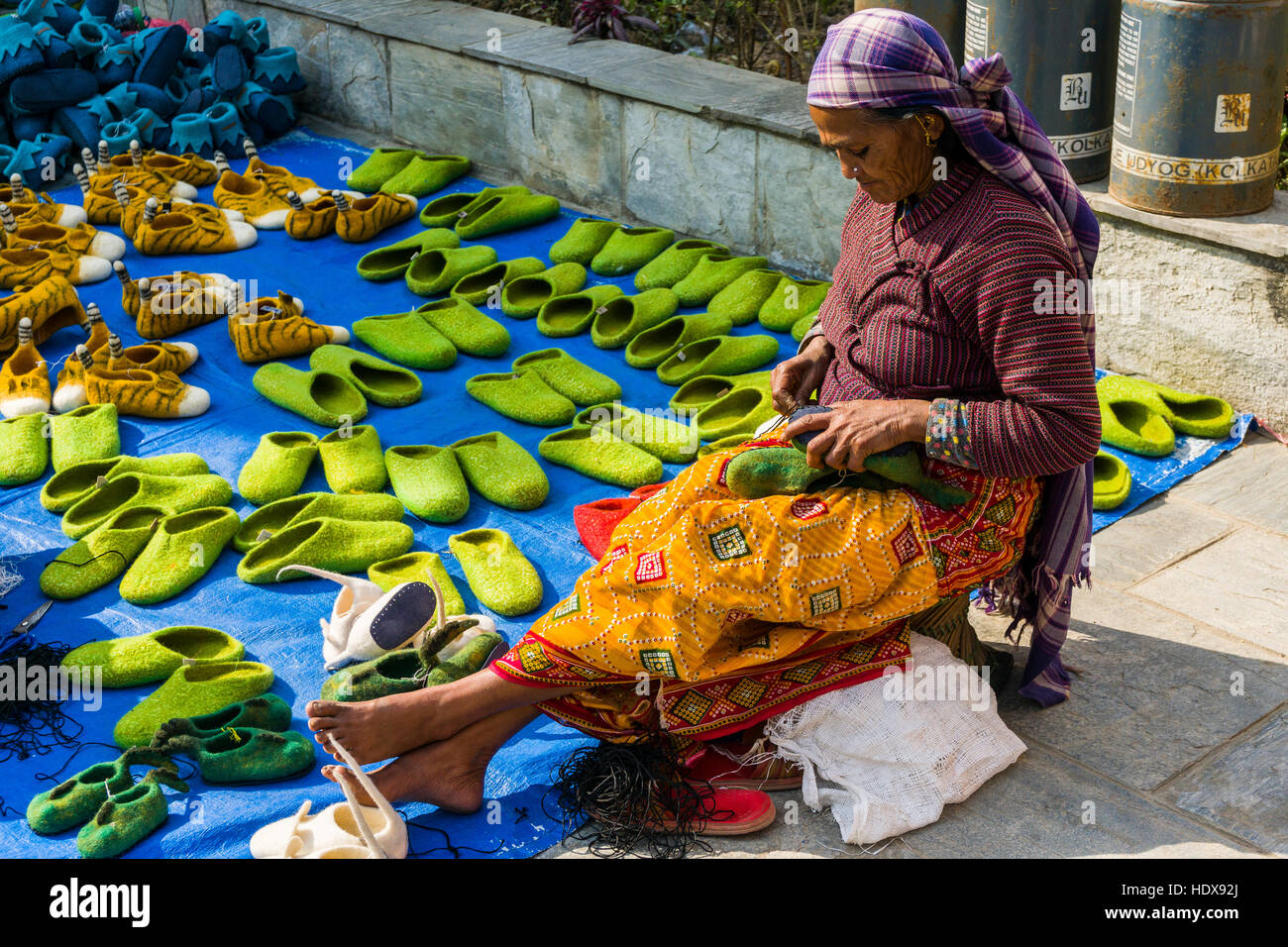 A woman is working at felt shoes Stock Photo