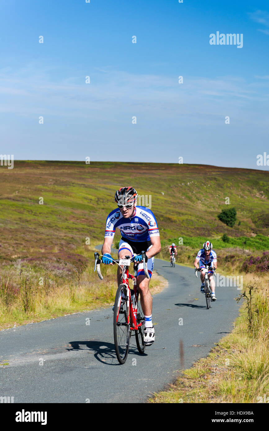 Bike racers riding up Danby Rigg Stock Photo