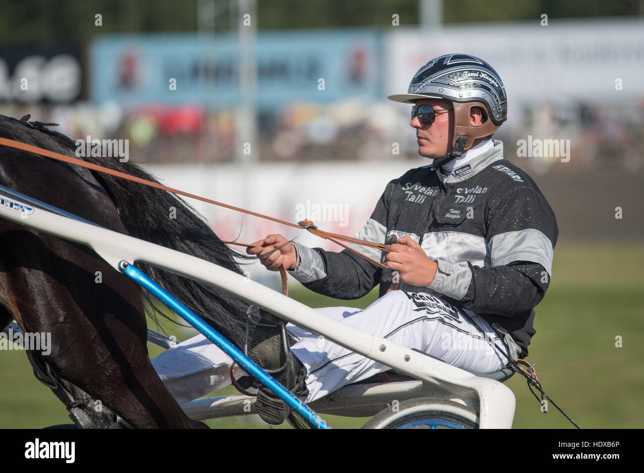Harness racing driver Tomi Haapio at a summer meeting at Axevalla harness  racing track Stock Photo - Alamy