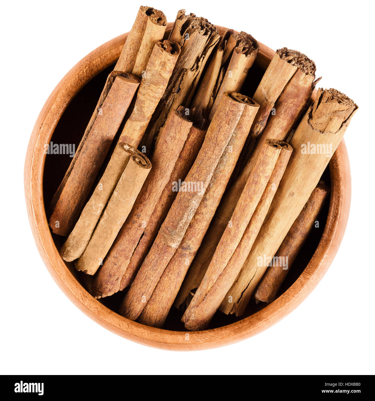 Cinnamon sticks in wooden bowl. Raw brown quills from inner bark of Cinnamomum. Cassia, aromatic spice used as condiment. Stock Photo