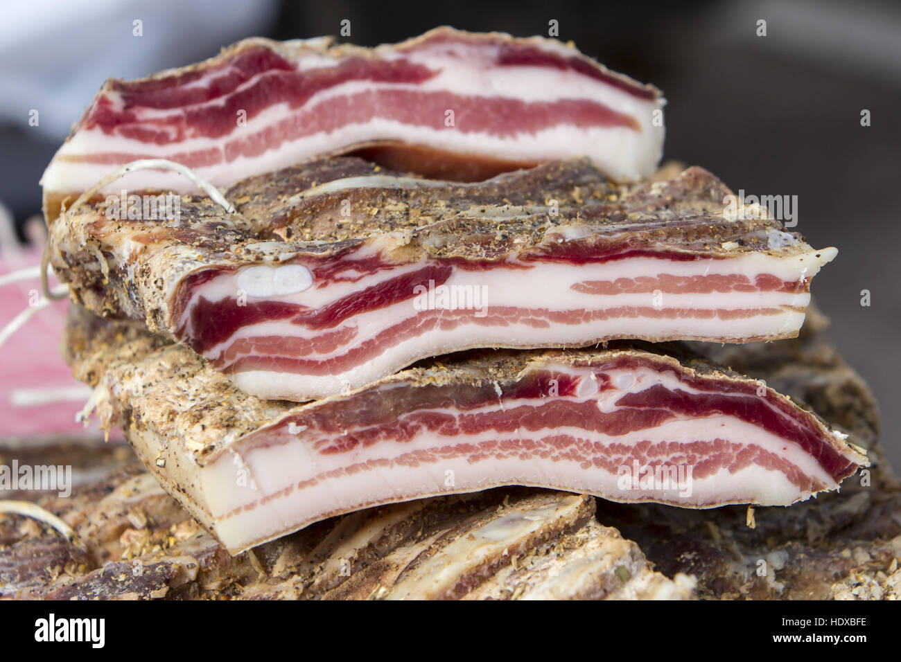 Pieces of smoked bacon on a street stand Stock Photo