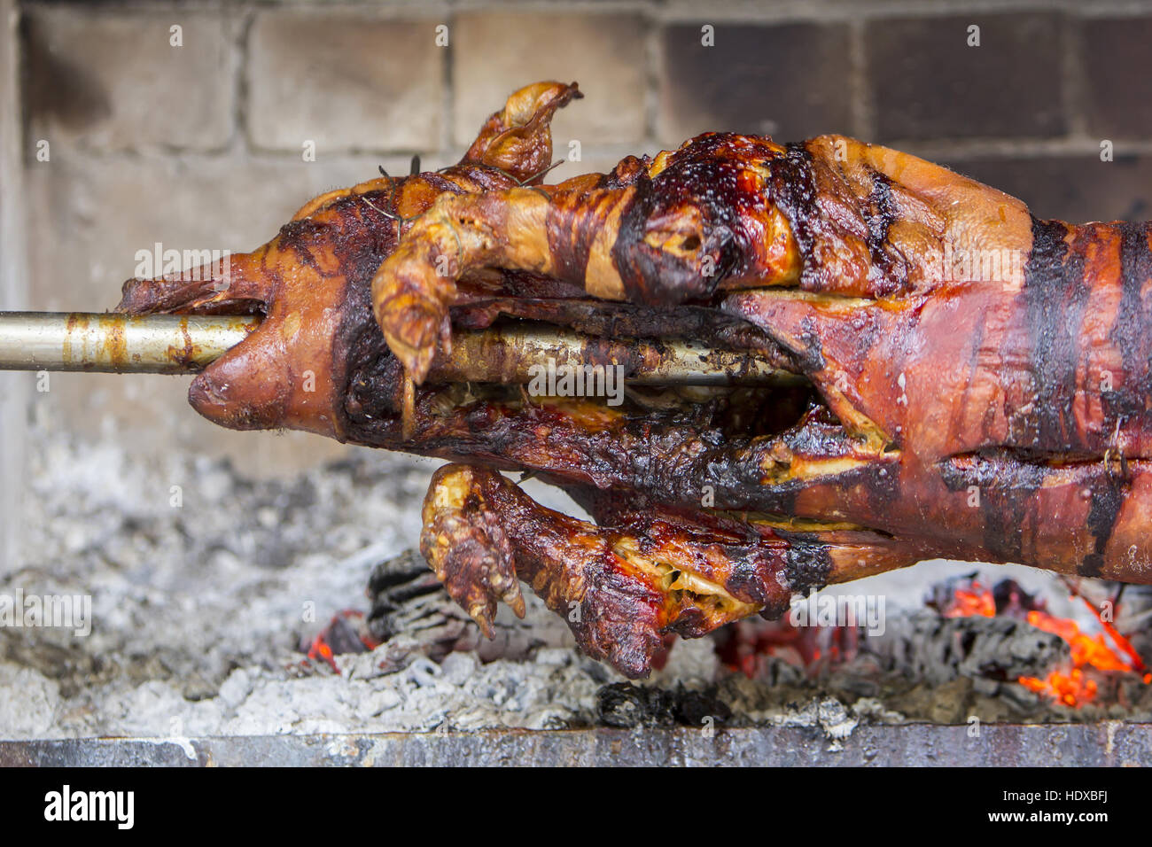 Roasting suckling pig on the broach Stock Photo