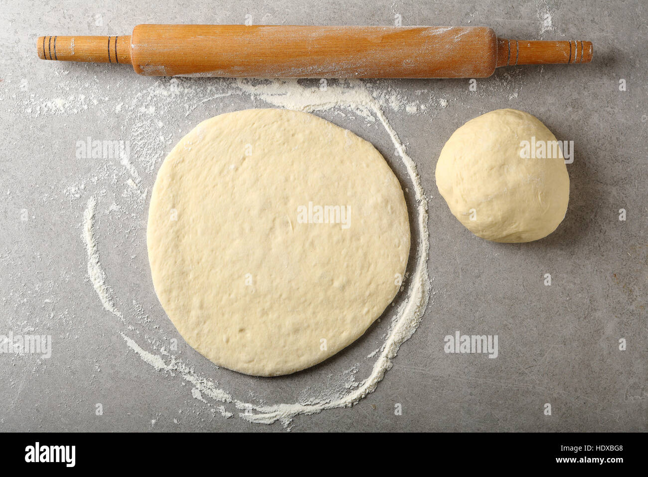 Pizza dough and rolling pin, food top view Stock Photo