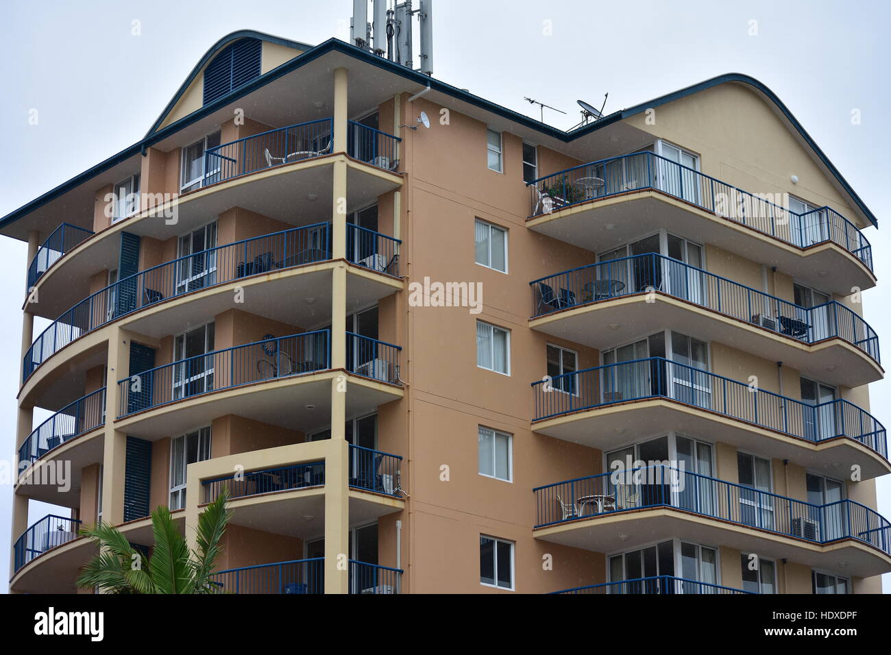 Apartment building with long balconies with metal railing along both ...