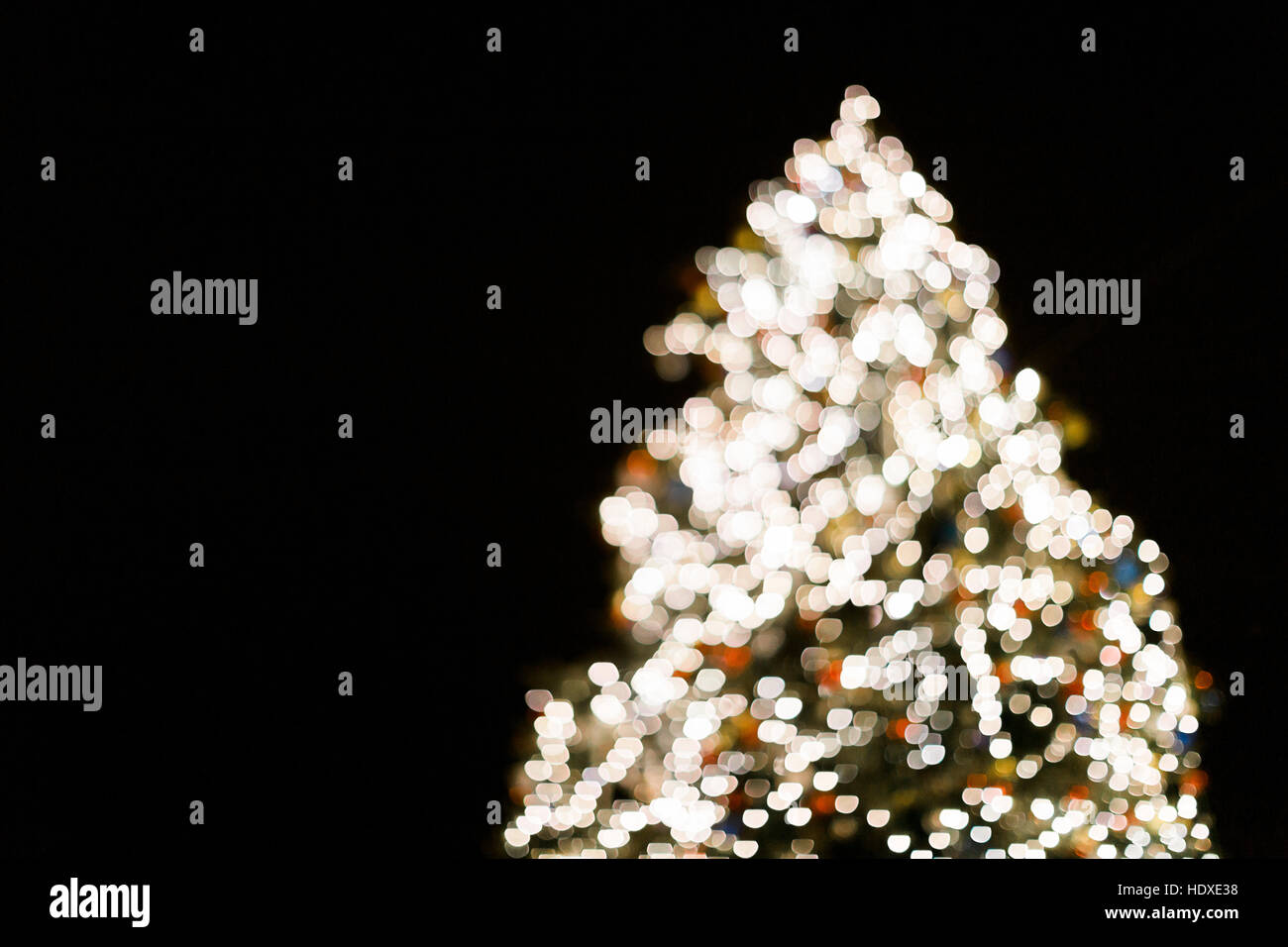 Christmas tree with lights glowing, blurred background Stock Photo Alamy