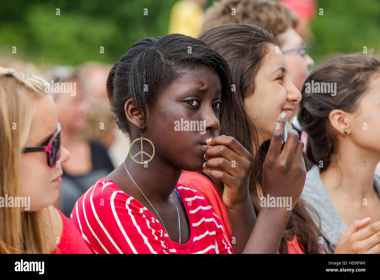 A girl with Peace mark earring. Stock Photo