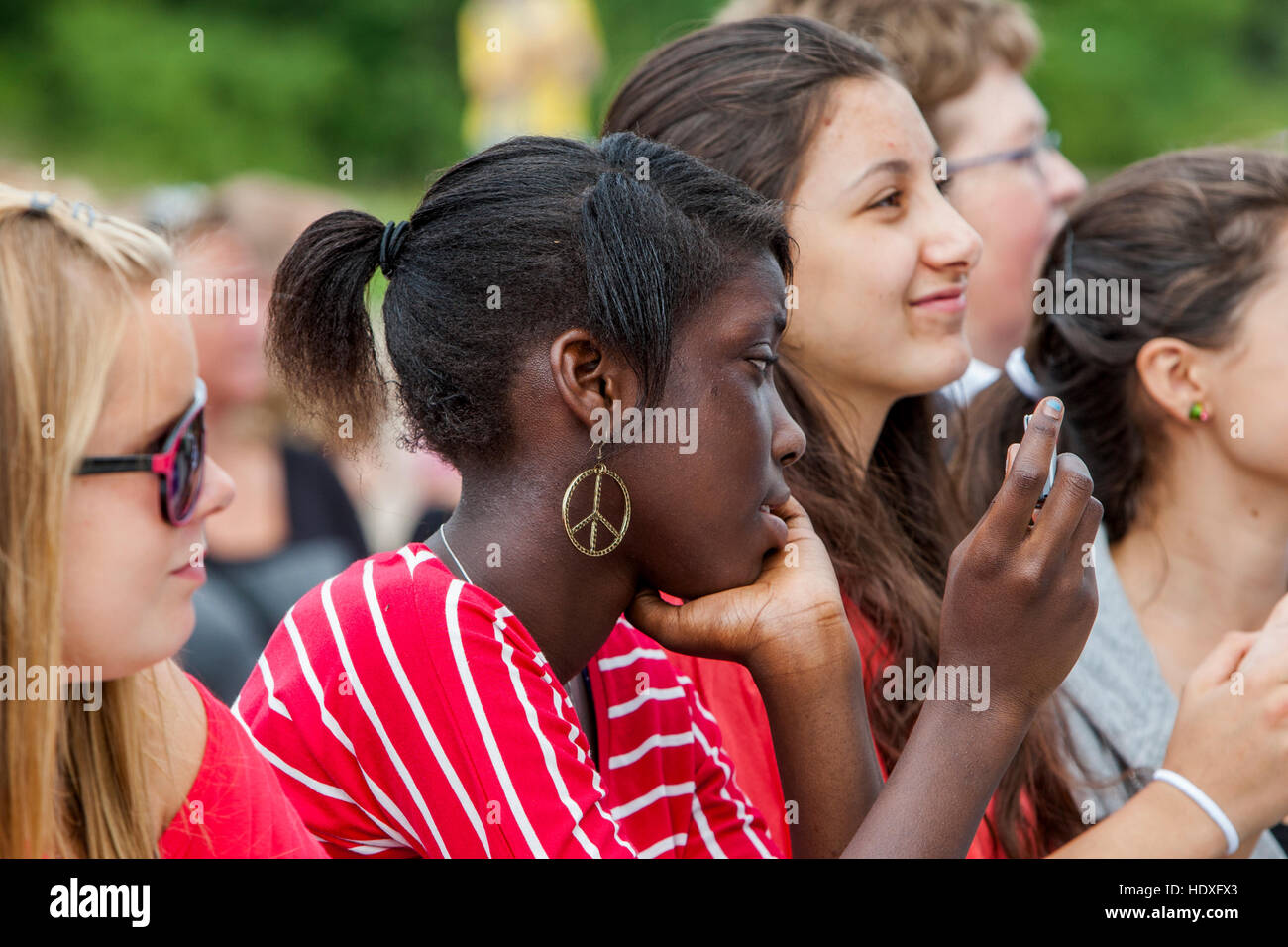 A girl with Peace mark earring. Stock Photo