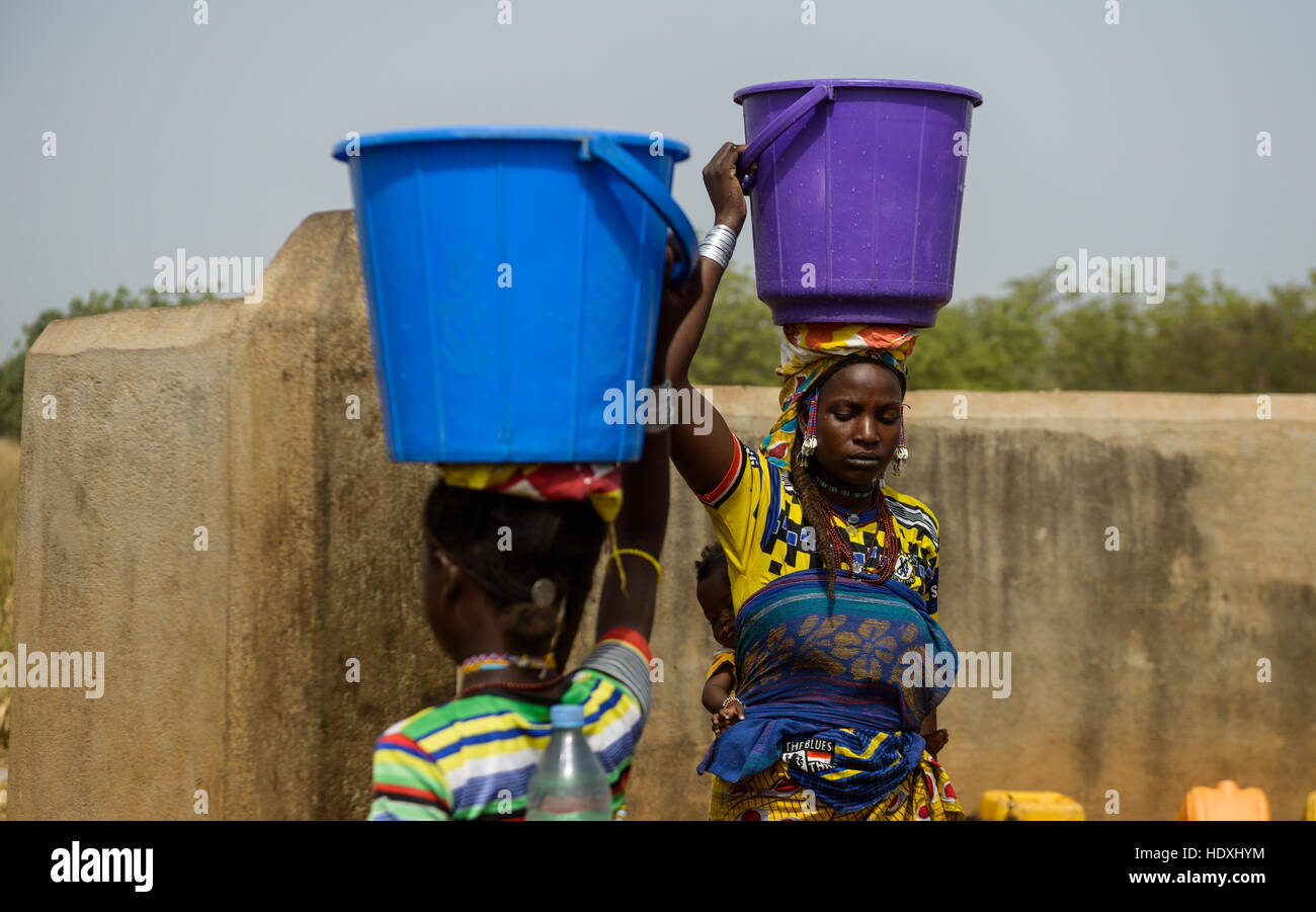 Fulani women getting water at the water pump, Northern Togo Stock Photo