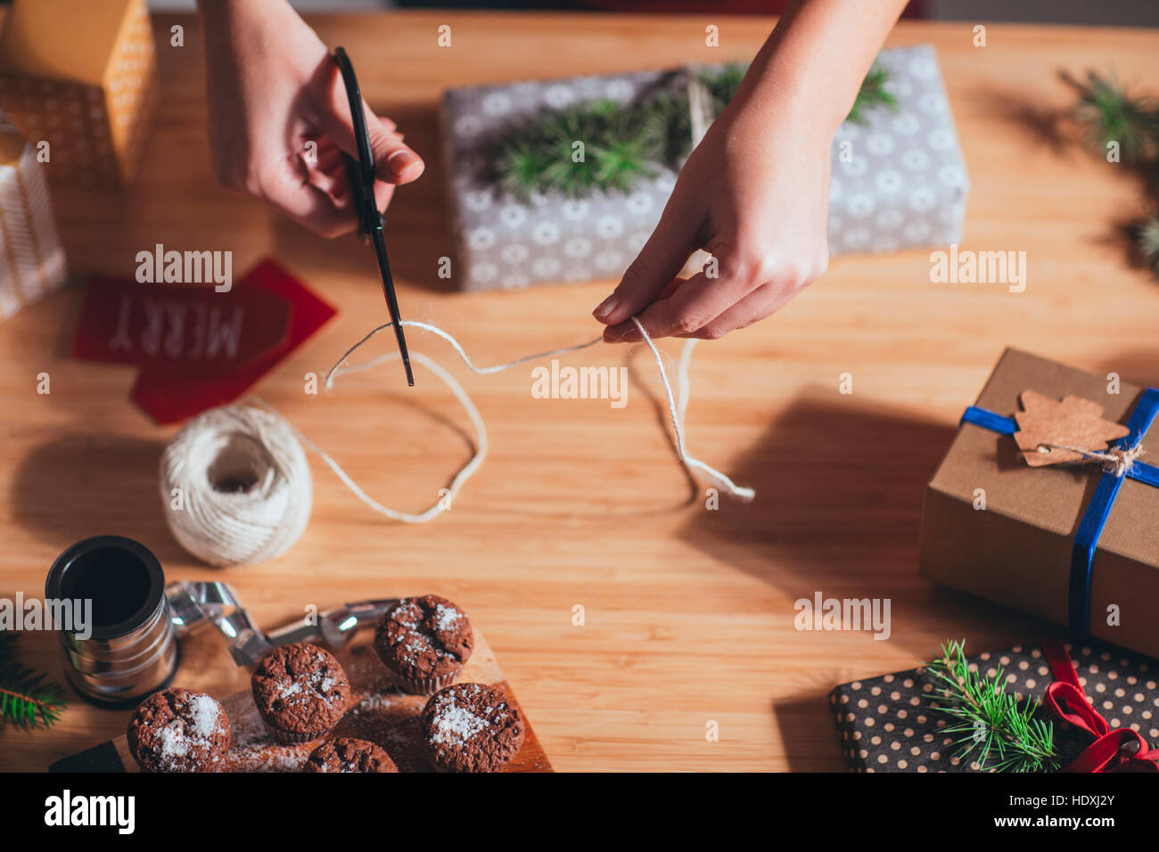 Woman wrapping and decorating Christmas present Stock Photo Alamy
