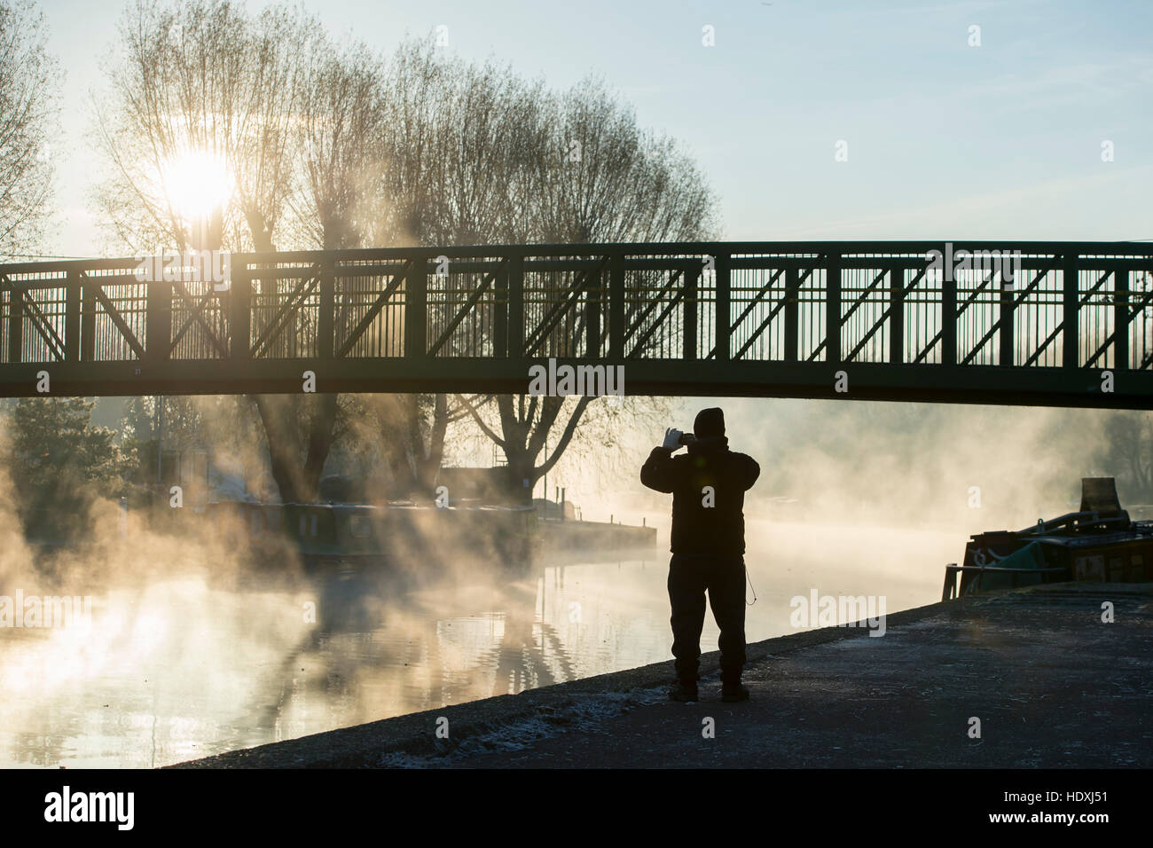 30th November, 2016. London, UK.  A man takes a photograph of the River Lea in Tottenham, London, on a cold misty morning. Photo: David Mirzoeff/ Alam Stock Photo