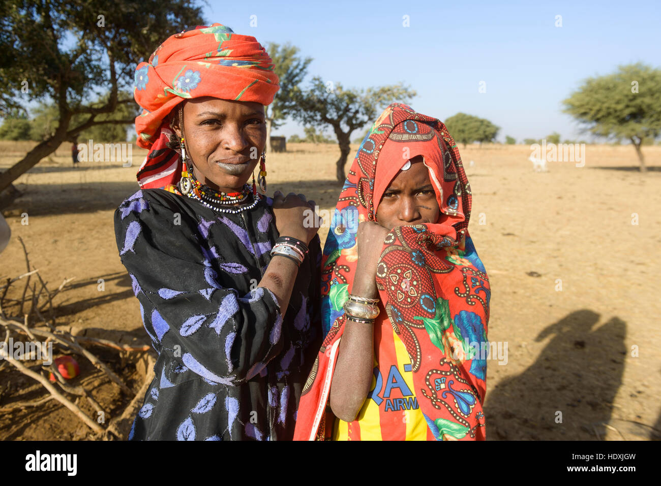 Fulani women gathering water from a hole in the Sahel, Burkina Faso Stock Photo