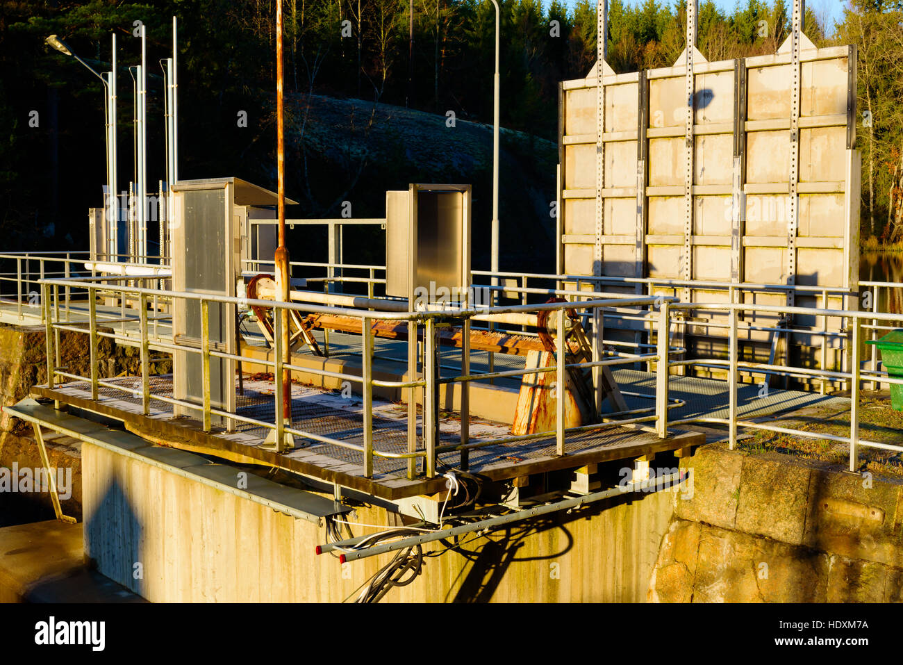 Dam gates at local hydroelectric power plant. One gate is closed and