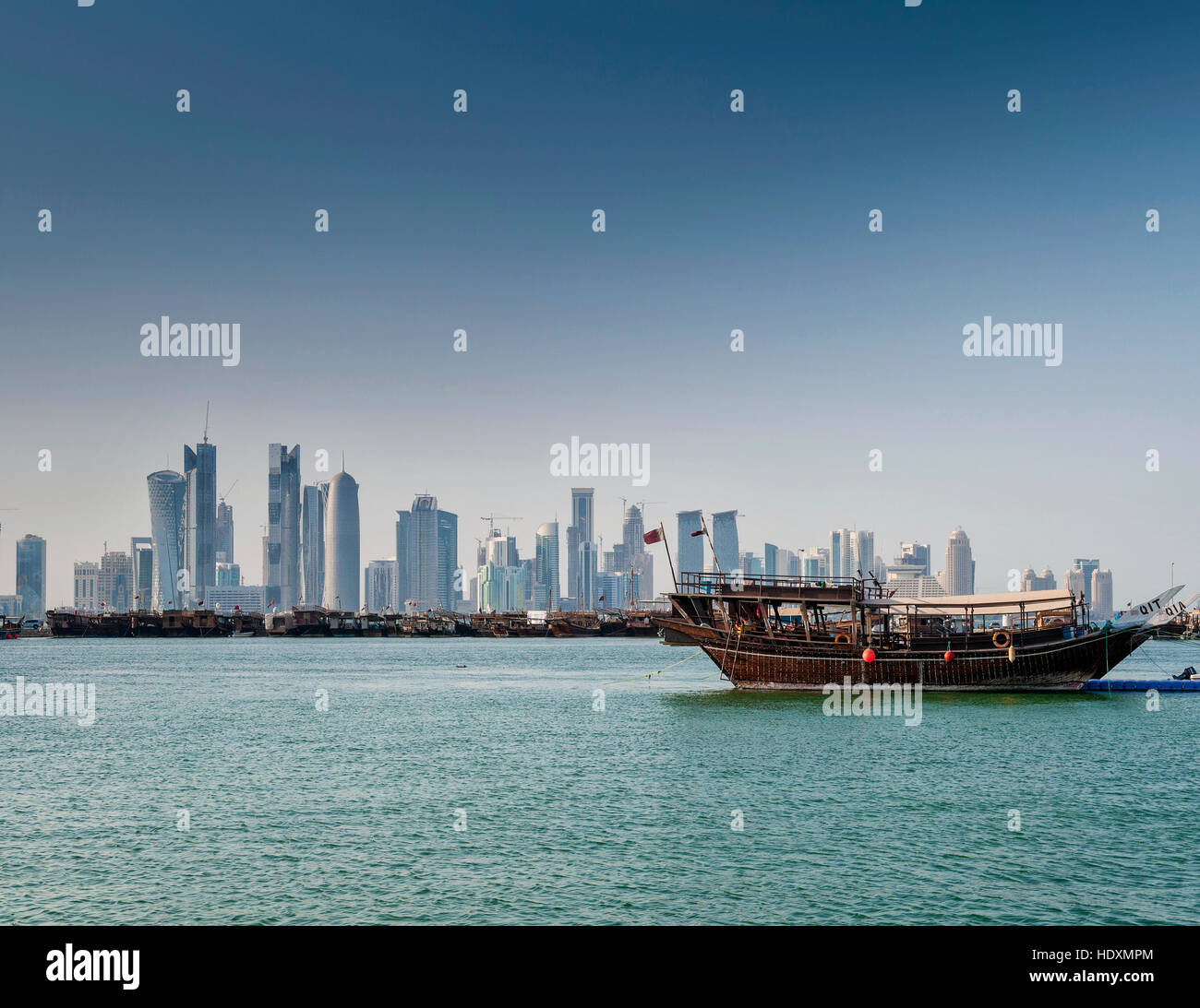 doha city skyscrapers urban skyline view and dhow boat in qatar Stock Photo