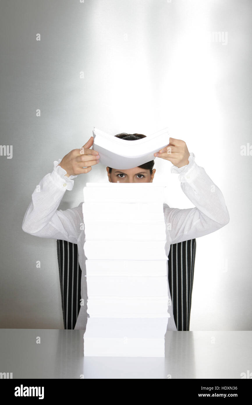 Businesswoman, aged 24, looking through sheets of paper Stock Photo Alamy
