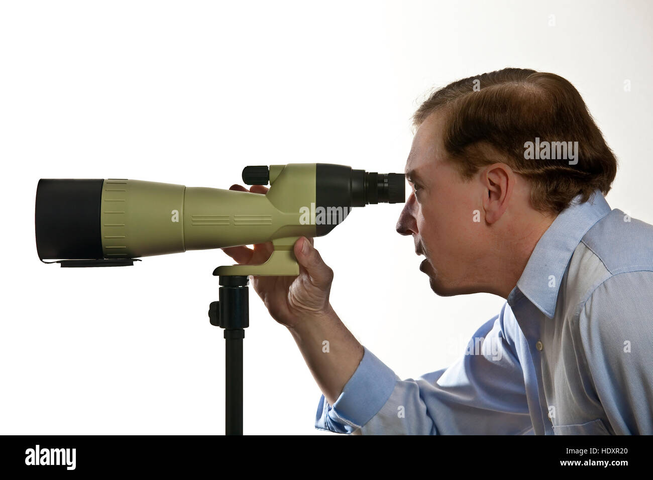 Older man looking through spotting scope Stock Photo Alamy
