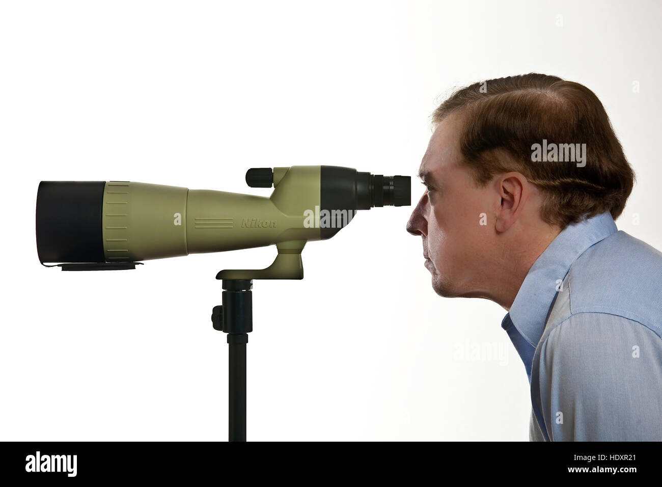 Older man looking through spotting scope Stock Photo Alamy