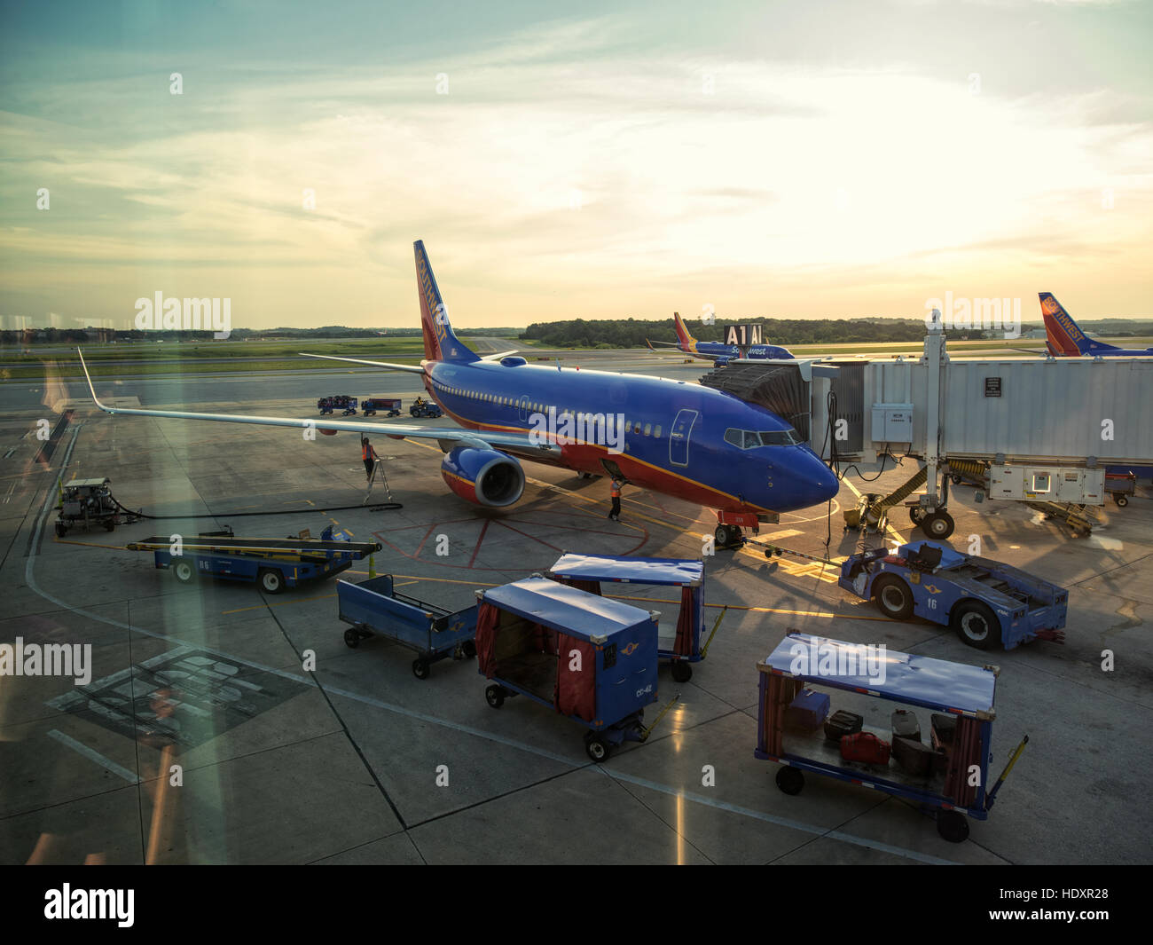 Airplane at an airport terminal gate preparing for an early flight. Baltimore Washington International, BWI. Stock Photo