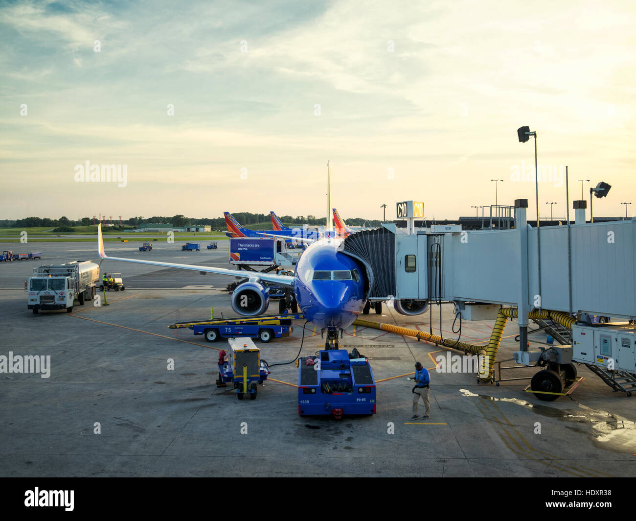 Airplane at an airport terminal gate preparing for an early flight. Baltimore Washington International, BWI. Stock Photo