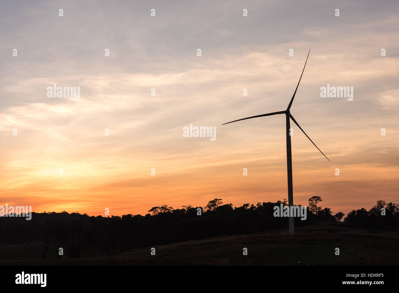 Wind power generation,Wind turbines on farmland and agricultural countryside with sunset at Phetchabun Province,Thailand Stock Photo