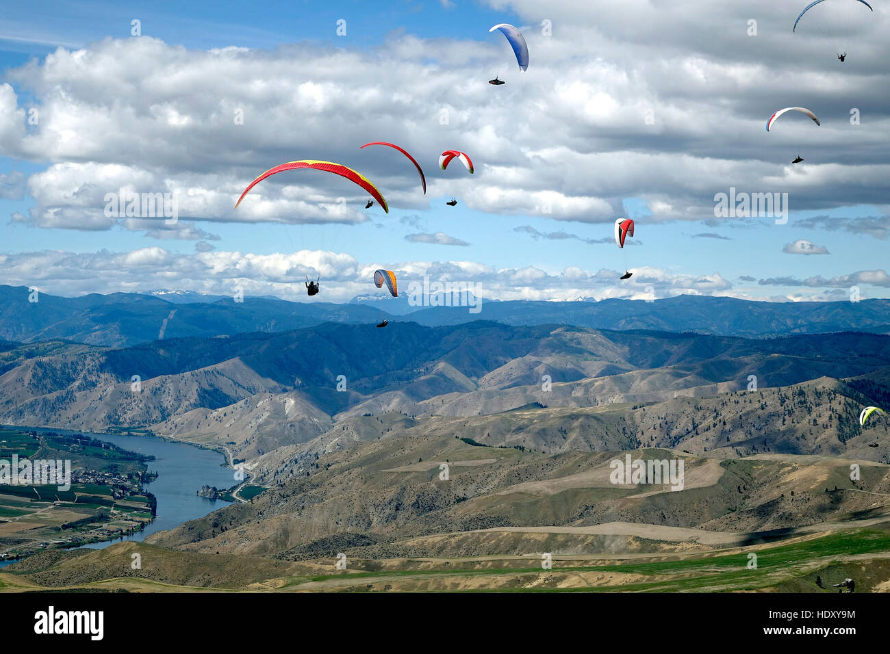 Paraglider pilots flying in a gaggle at the U.S. National Paragliding Championships in Chelan. Stock Photo