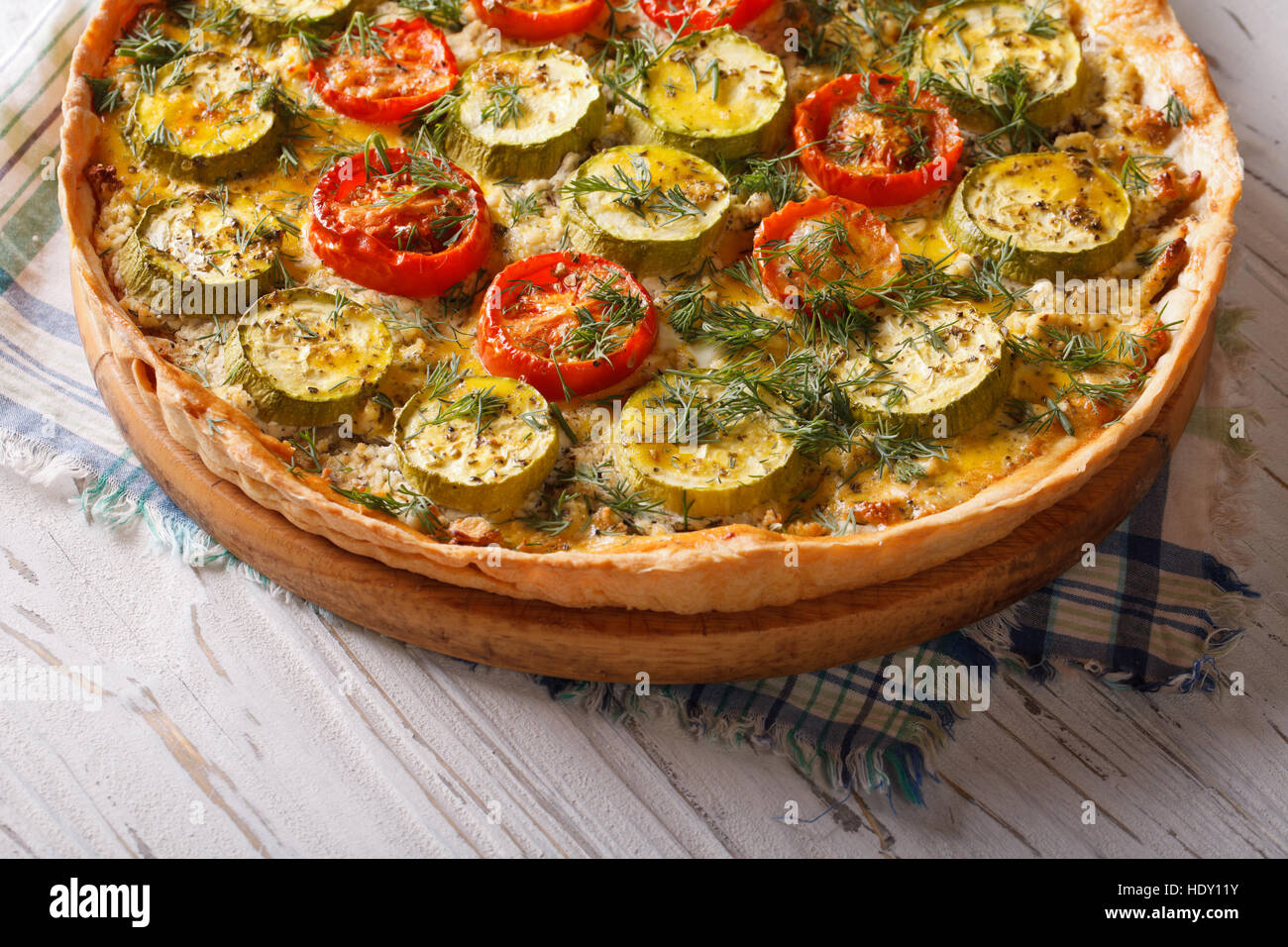 rustic vegetable quiche with cheese tomatoes and zucchini closeup. horizontal Stock Photo