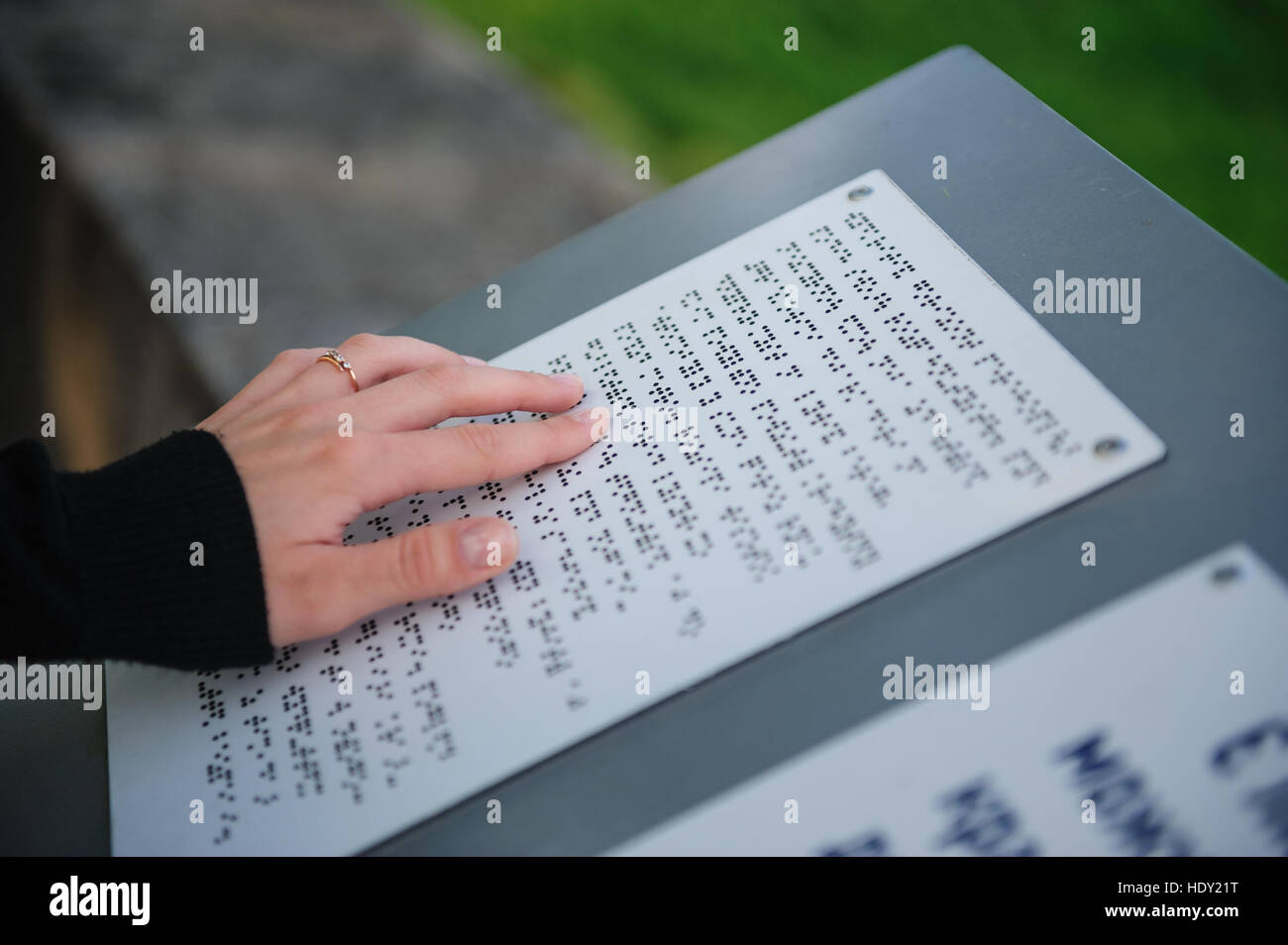 text for the blind on metal plate in park Stock Photo Alamy
