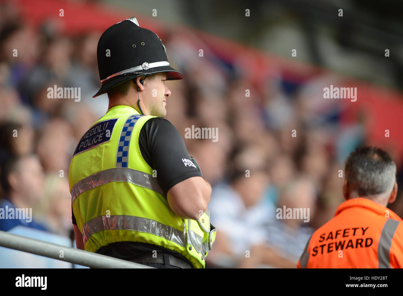 A UK police officer at a sporting event. Stock Photo